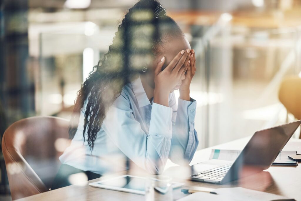 Stress, anxiety and burnout with a business woman suffering with mental health in her office at wor
